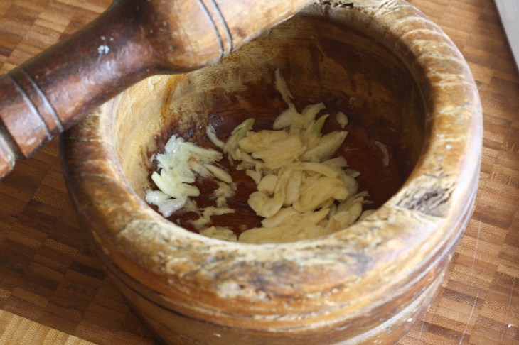My grandfather's mortar and pestle-one of my priceless kitchen appliances and the absolute best for crushing garlic. Add a sprinkle of salt to help break down and crush garlic. 